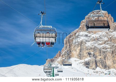 Chair lift with skiers at ski resort