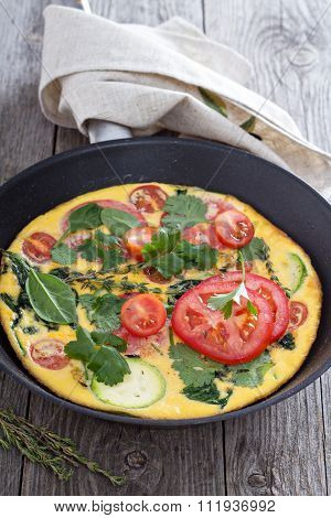 Fresh fritatta with zucchini and tomatoes