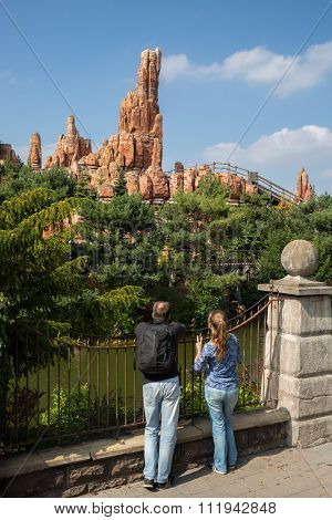 Tourists is watching the high beautiful landscape with roller-coaster.