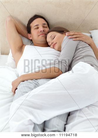 Cute Couple Sleeping In Each Other's Arms On Their Bed