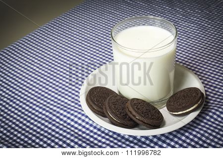 Milk With Cookies On A Blue And White Map