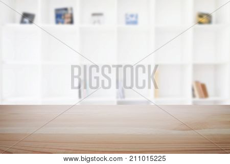 Empty wooden table and blur background of abstract in front of modern library or knowledge source can be used Mock up for display of product or for montage.