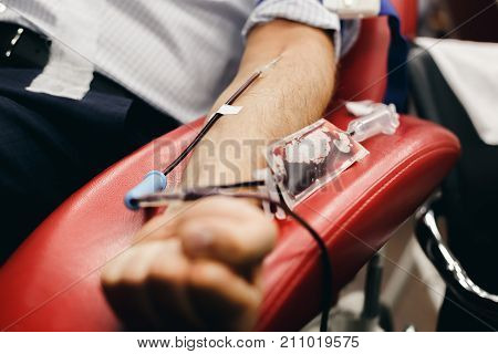 The donor blood donates blood in the clinic on a special chair. Blood sampling procedure for blood bank