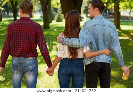Friendship love jealousy adultery polygamy concept. Love triangle. Young woman in relationship with two men.