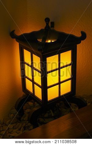 Decorative lantern in a Japanese style in a corner near the table