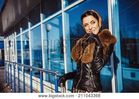 Beautiful business woman standing with a bag at the airport.