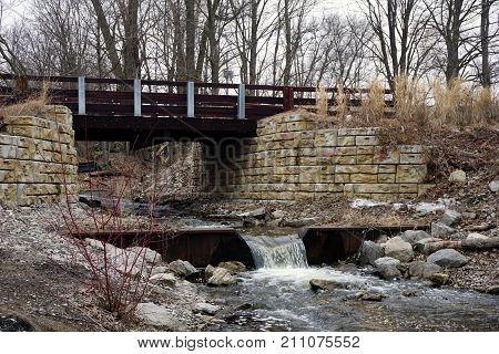 A bridge, along the Little Traverse Wheelway, which connects Charlevoix, Petoskey and Harbor Springs, Michigan, allows hikers and bicyclists to cross Tannery Creek.