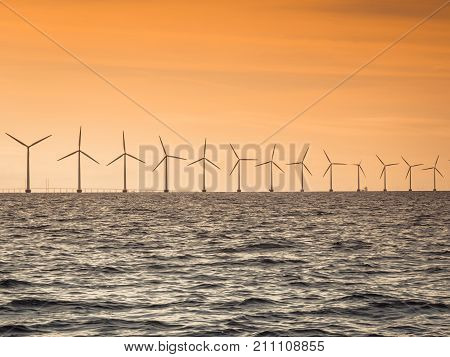 Wind turbines generator farm for renewable sustainable and alternative energy production along coast baltic sea near Denmark. Eco power ecology.