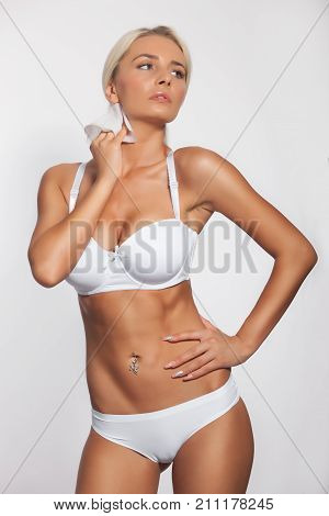 Young woman cleaning neck with wet wipes body breast lingerie