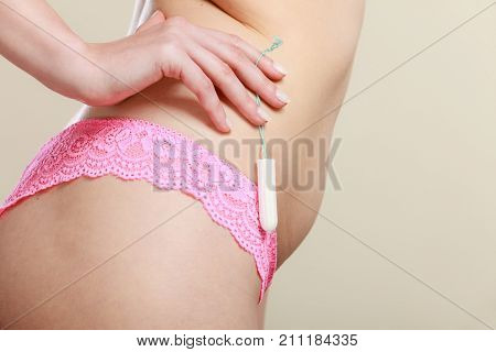 Girl Holding Tampon During The Monthly Cycle