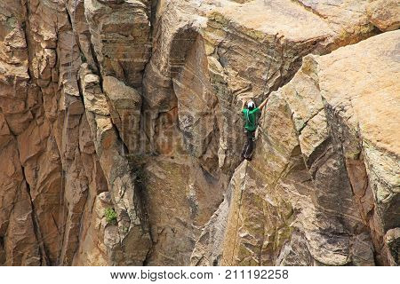 TUCSON, ARIZONA, USA --April 19, 2014:  Man top rope climbing a hoodoo near Windy Point on Mount Lemmon in Tucson, Arizona, USA in the Santa Catalina Mountains located in the Coronado National Forest with copy space.