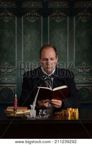 victorian business man reading is money ledger