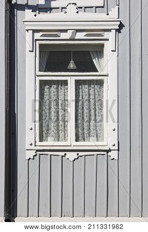 Traditional grey wooden house facade in Rauma town. Finland heritage. Vertical