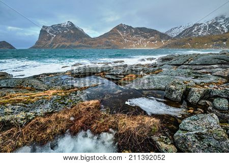 Rocky coast of fjord of Norwegian sea in winter. Lofoten islands, Norway