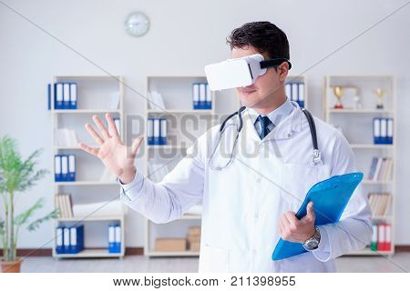 Young doctor with vr virtual reality headset working in the offi