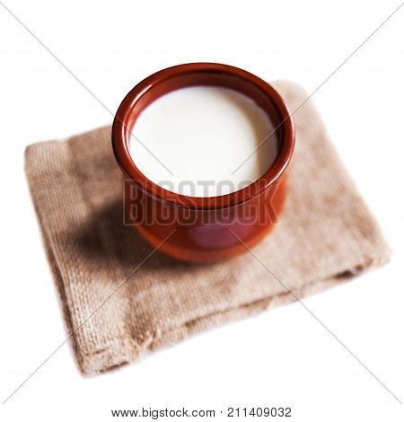 Yogurt cream or Cottage cheese curd in clay pot isolated on a white background. Traditional Cuajada sour cream