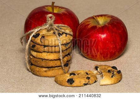 Chocolate Cookies And A Red Apple On Background Burlap
