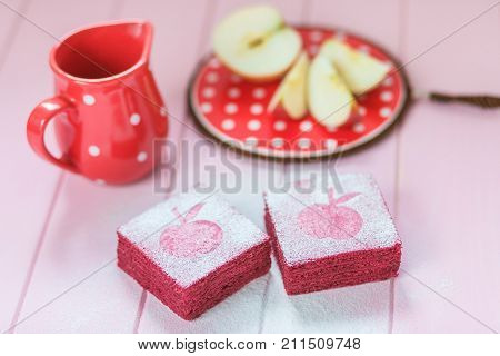 Afternoon tea ceremony, fresh apples, square currant pastila cake covered with powdered sugar.