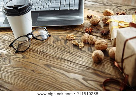 Workplace with laptop and coffee. Preparing for Christmas and new year.