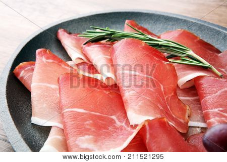 prosciutto with rosemary or ham of black forest or serrano.