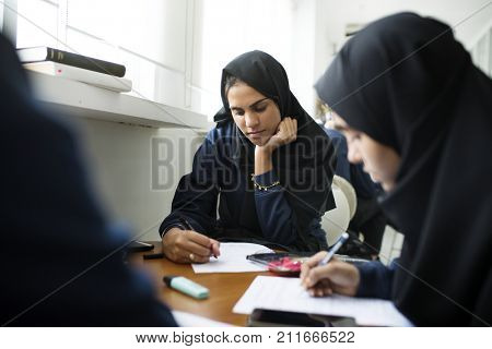diverse muslim girls studying in classroom