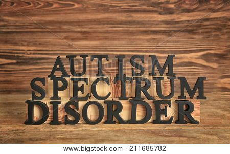 Text AUTISM SPECTRUM DISORDER on wooden table