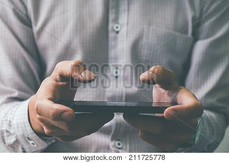Business process photo. Account manager using mobile phone. Typing contemporary smartphone screen.