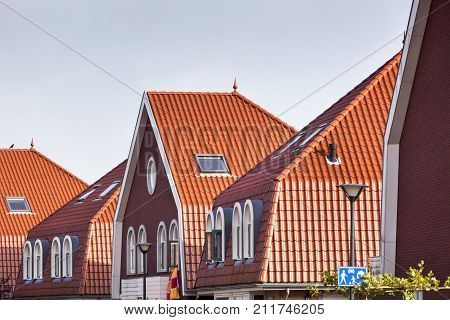 Modern red tiled roofs in residential district Fascinatio in Capelle aan den IJssel in the Netherlands