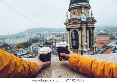 two cups of coffe panormaic view to old european city in autumn day