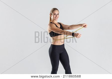 Perfect Body. Attractive Girl Holding Centimeter And Smiling.