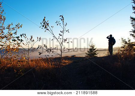 Silhouette Of One Young Man Standing With His Back Turned