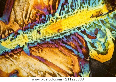 colorful microscopic shot of salt acid microcrystals in polarized light