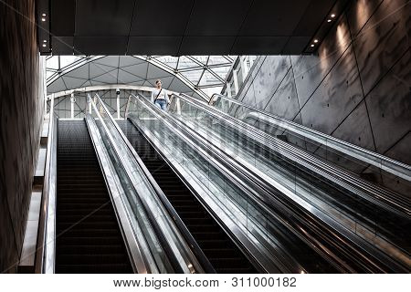 Woman Going Down The Escalator At The Railway Station Triangeln In Malmoe, Sweden, May 21, 2019