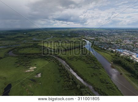 Irbit City And River. Russia. Aerial. Summer, Cloudy.  A Lots Of Trees And Grass