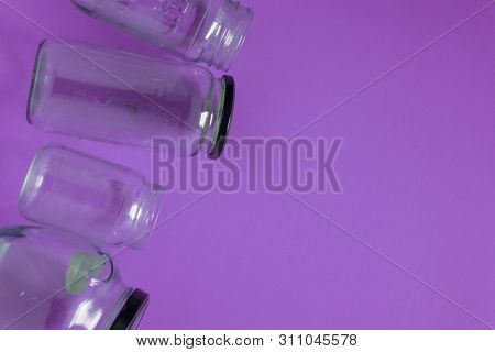 Isolated Glass Jars, Flat On Violet Purple Background, Room Copy Space Right