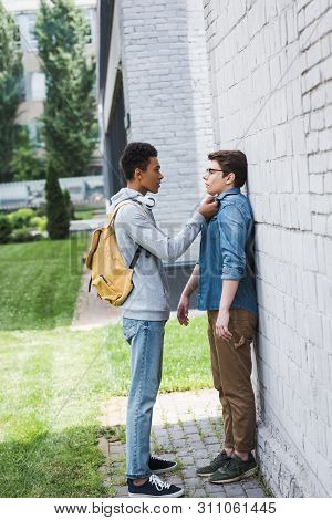 African American Boy In Hoodie And Jeans Bulling Boy In Glasses