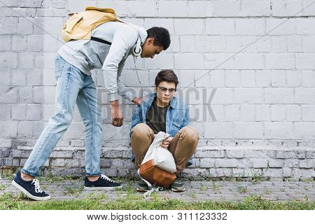 African American Boy In Hoodie And Jeans Bulling Boy In Glasses