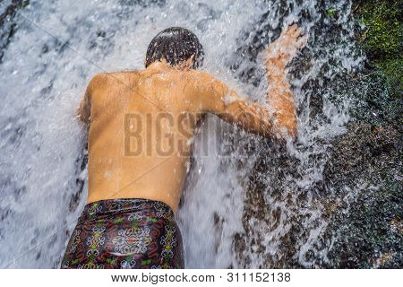 Young Man Tourist In Holy Springs Sebatu In Bali