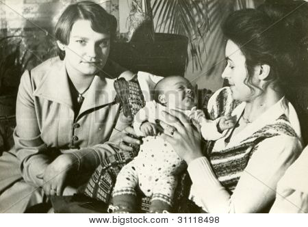 Vintage photo of young mother and aunt with a baby boy (early eighties)
