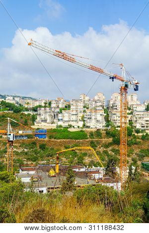 Haifa, Israel - July 12, 2019: Construction Site Of Apartment Buildings, With Workers. Its An Urban 