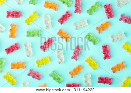 Flat Lay Composition With Delicious Jelly Bears, Jelly Bears Pattern On Azure Background