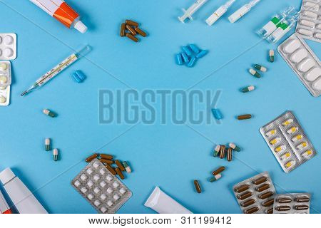 Flat Lay Of Medicine Pills, Salve, Ampoules And Thermometer