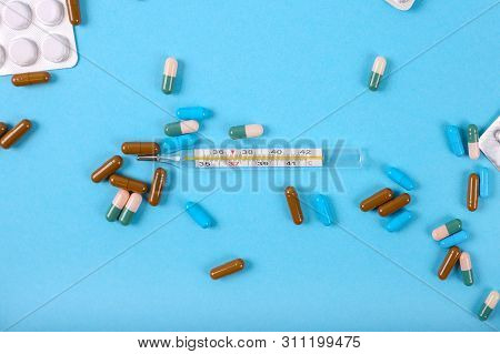 Flat Lay Of Medicine Pills And Thermometer