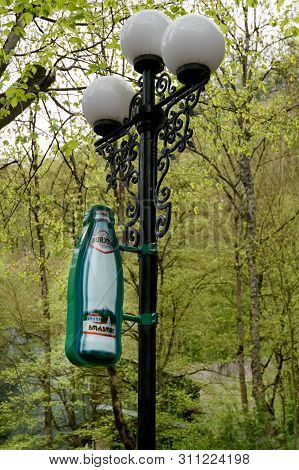 Borjomi, Georgia - May, 04 - 2019: Symbol Of Borjomi - Bottle Of Mineral Water As Decoration On Latt