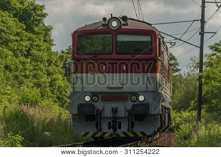 Passenger Diesel Red Big Train Near Kysak Station In Summer Hot Blue Sky Morning