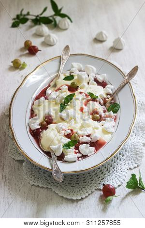 Eton Mess, Traditional English Dessert With Gooseberry, Whipped Cream And Meringue On A Light Backgr