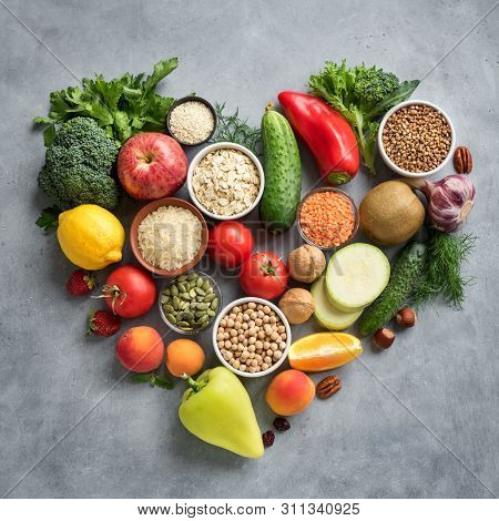 Healthy Vegan Food Background - Organic Food In Heart Shaped Flat Lay, Top View. Healthy Clean Eatin