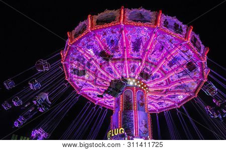 Munich, Germany - September 26, 2015: Nightshot Of The Wellenflug Carousel In Motion At Oktoberfest 