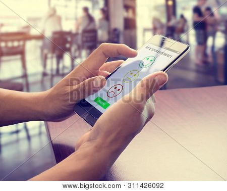 Men Hand Using Smart Phone Choose Icon Face Smile Symbol. Customer Service Experience And Business S
