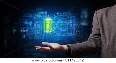 Elegant hand holding battery with full of energy